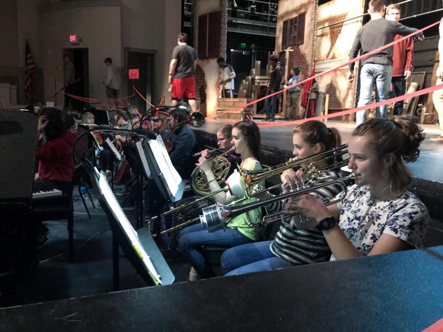Members of pit orchestra play during rehearsal.
