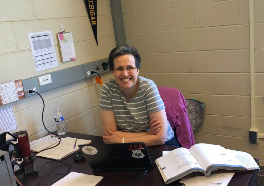 Mrs. Mons poses in her classroom