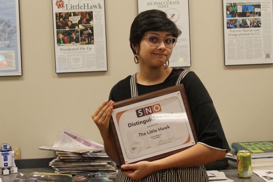 Mira Bohanna Kumar Little Hawk Web Editor holding the SNO distinguished Site Award 