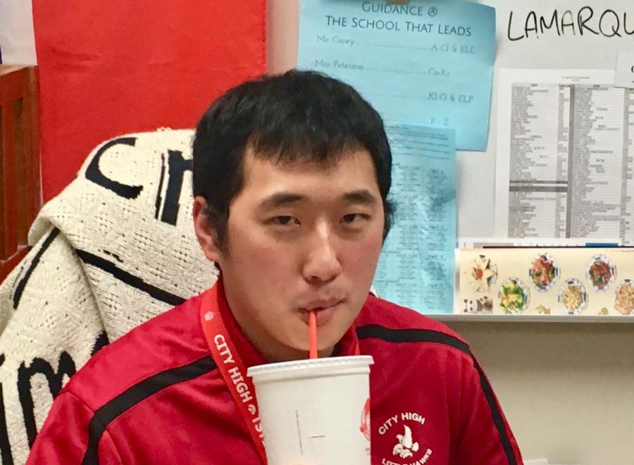Choir director Tyler Hagy sits in his office drinking a his favorite soft drink, a coke.