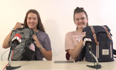 Two City High students compare the contents of their back to school backpacks.