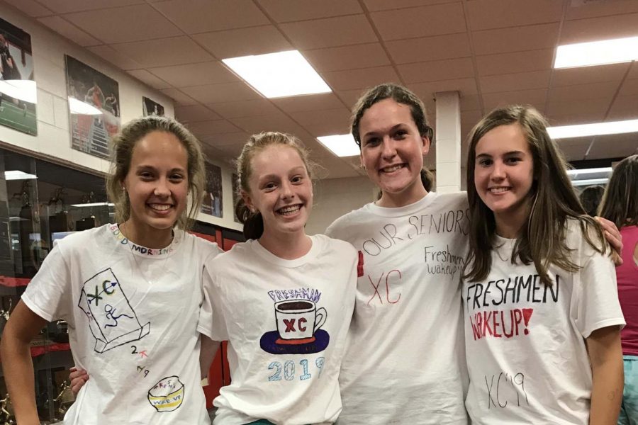 Bella Skay 23, Natalie Kuhlmann 23, Jenny Gidal 23 and Eva Reynolds 23 posing in their freshman wakeup shirts. 