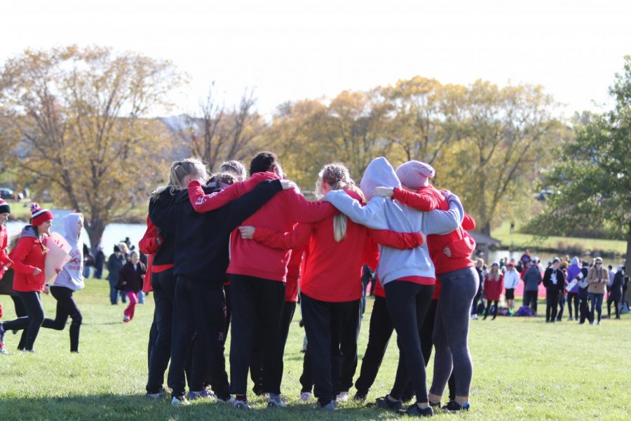 Girls Cross Country forms a team huddle before the District Meet on Thursday. 