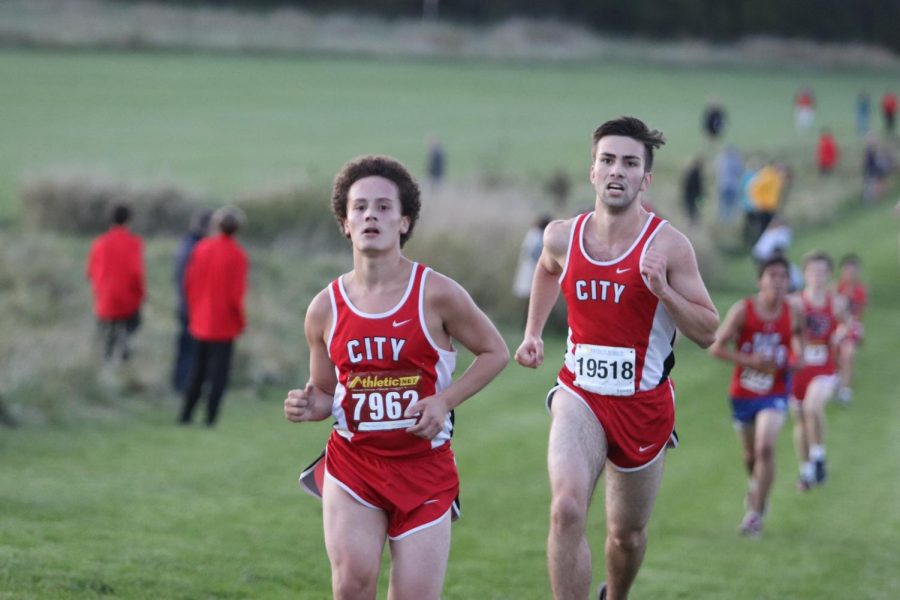 Atticus Ojile 20 and Luis Abreu 21 run together during the cross county meet on Thursday October 17, 2019