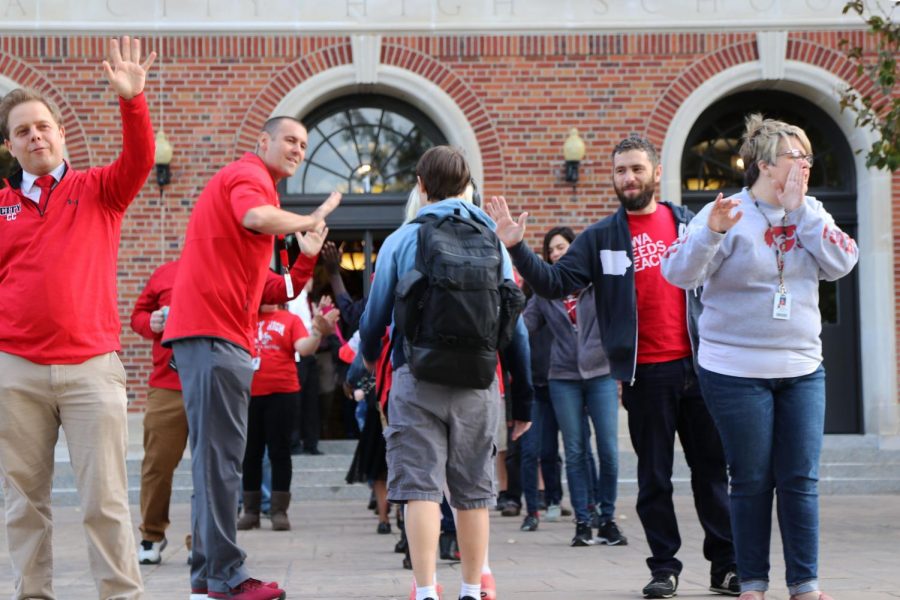 Principal John Bacon greets students with a smile.