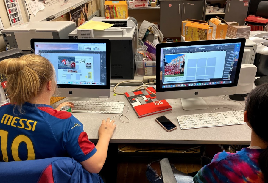 Natalie Green and Anna Gayley work on fall pages of the yearbook.  Students can sign up for the yearbook class with their guidance counselor.