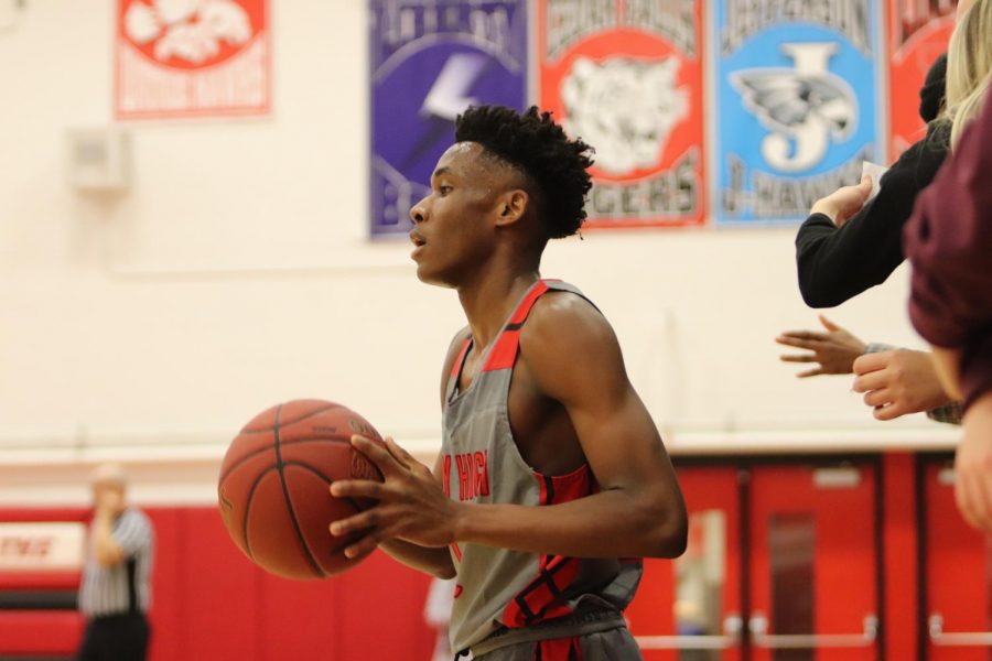 Byron Benton 21 getting ready to pass the ball in the game against Muscatine. 