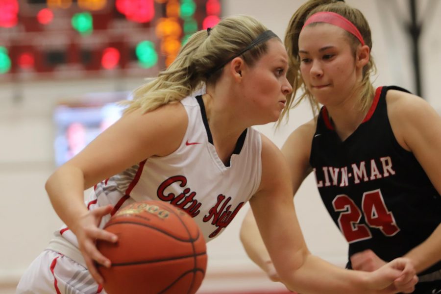 Paige Rocca 20 dribbles around a defender and drives to the basket. 