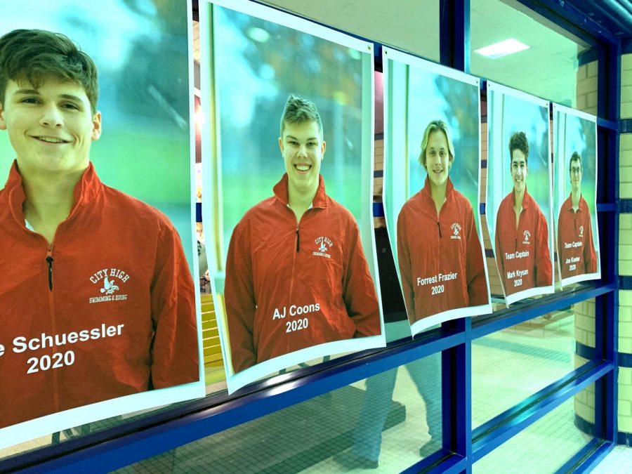 The seniors pictures hang in the window at Mercer Park Aquatic Center.
