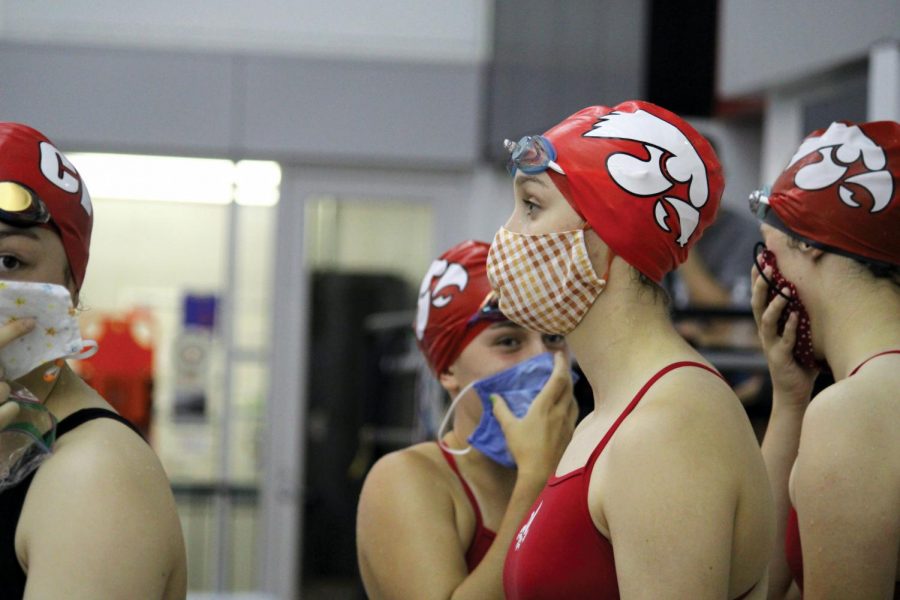 City High swimmers prepare for their events at a dual meet against Linn Mar