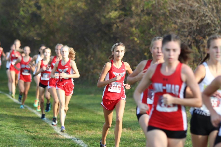 Rowan Boulter 22 leading the City High Varsity Girls behind her, closing in on Linn Mar. Boulter finished with a time of 19.30.