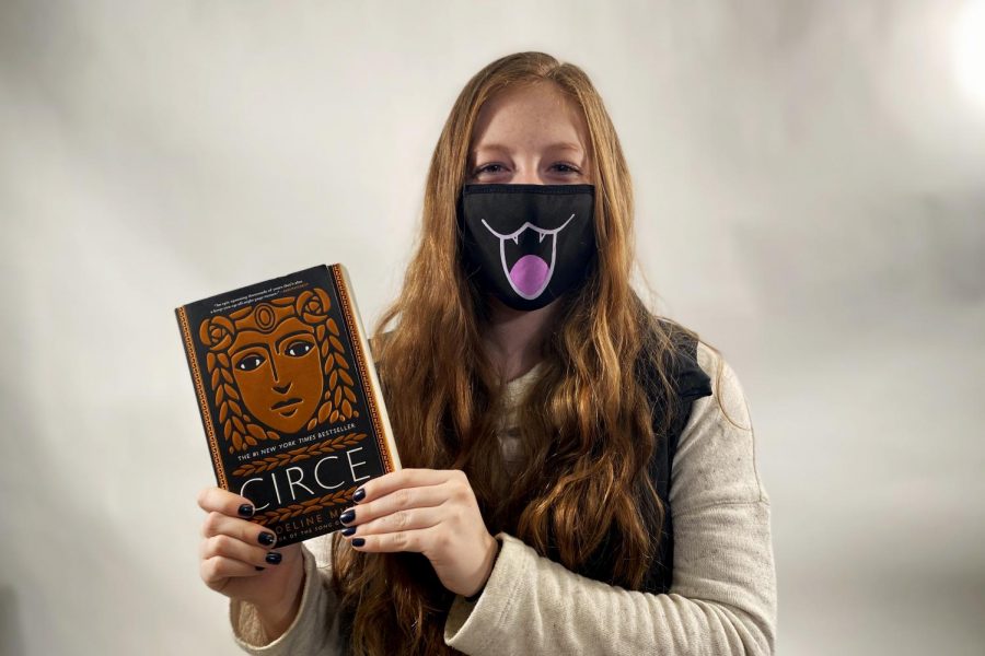 Kate Kueter 21 holds the book Circe by Madeline Miller.