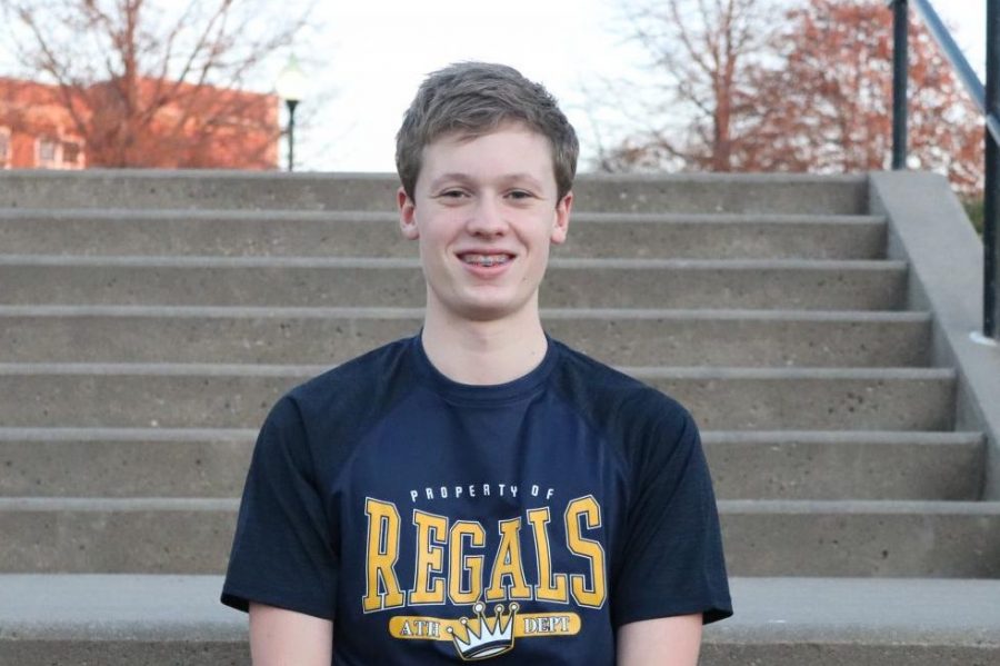 Joe Polyak 24 poses for a picture on the front steps of City High. He is enrolled at Regina but swims on the City High boys swim team.