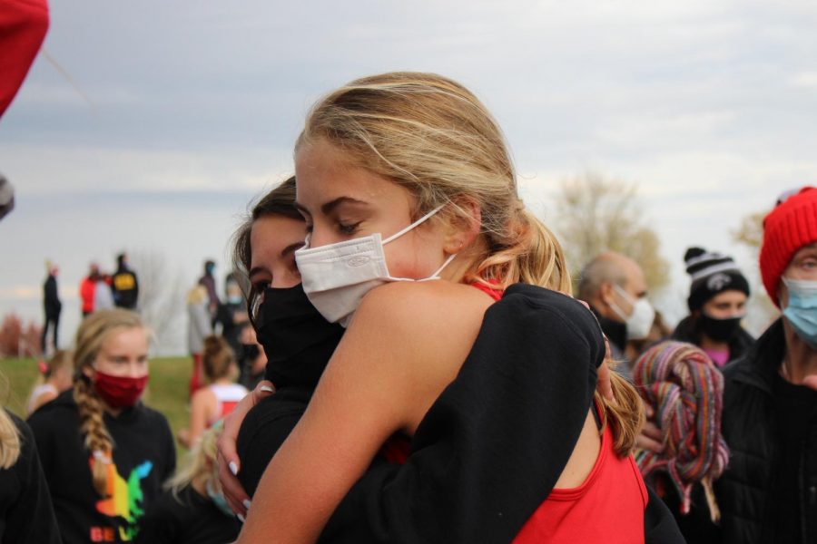 Rowan Boulter 22 hugs Janie Perrill 21 after the conclusion of the girls varsity race. 