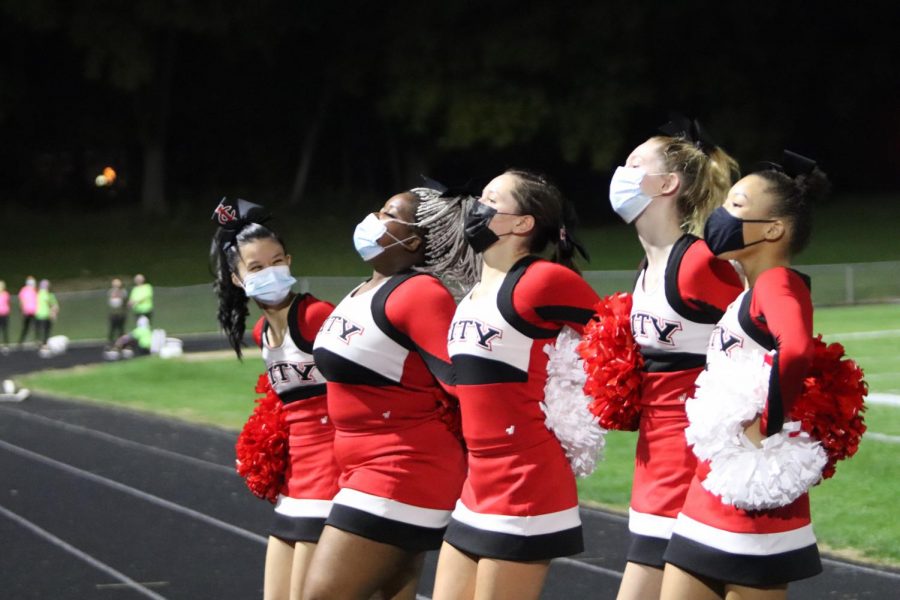 The City High cheer team pumps up the student section during footballs season opener. On August 28, City defeated Davenport Central 35-14.  