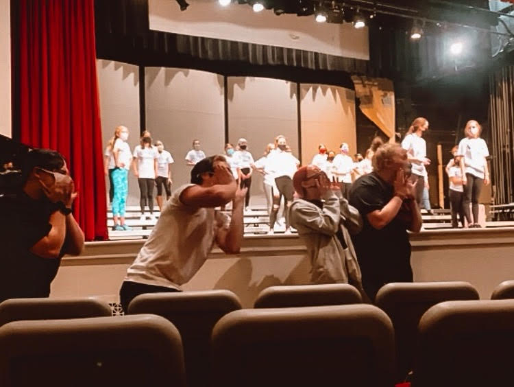 Senior members of Fourth Avenue Jazz Company cheer on junior varsity Charisma during their rehearsal.