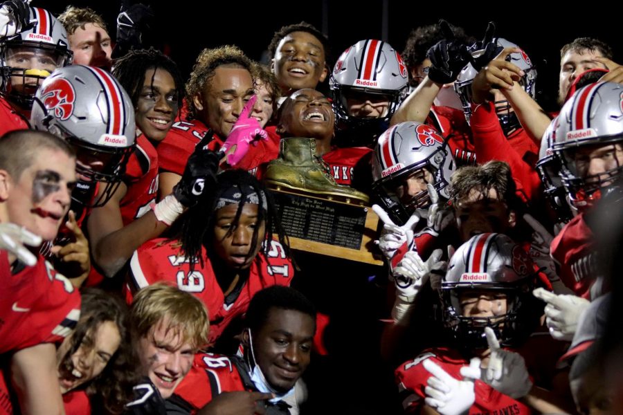 The City High football team holds the boot for a picture.