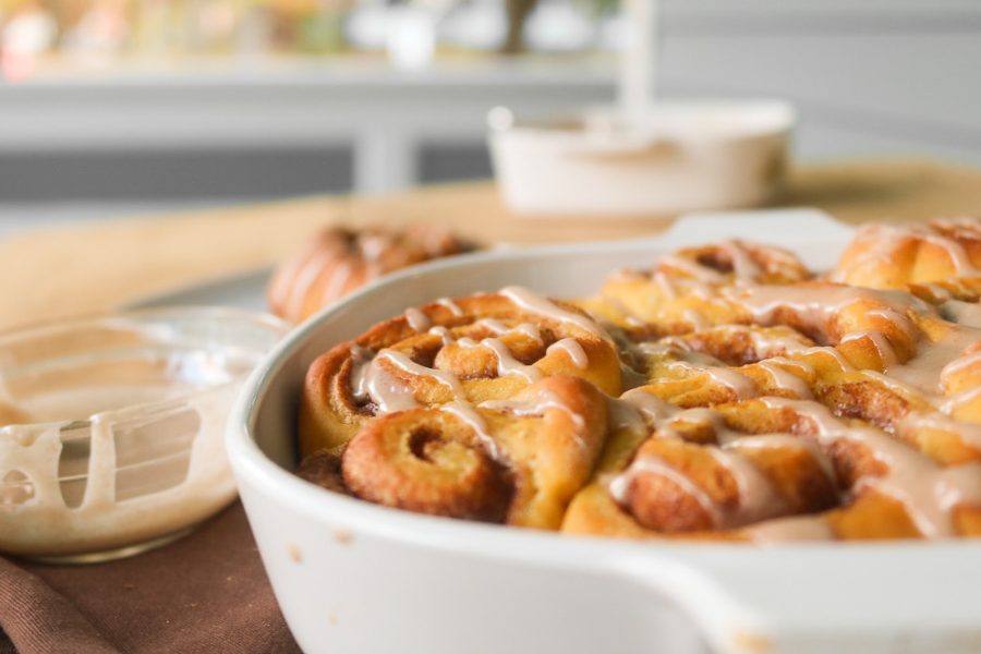 Freshly+baked+pumpkin+cinnamon+rolls+are+glazed+with+icing.