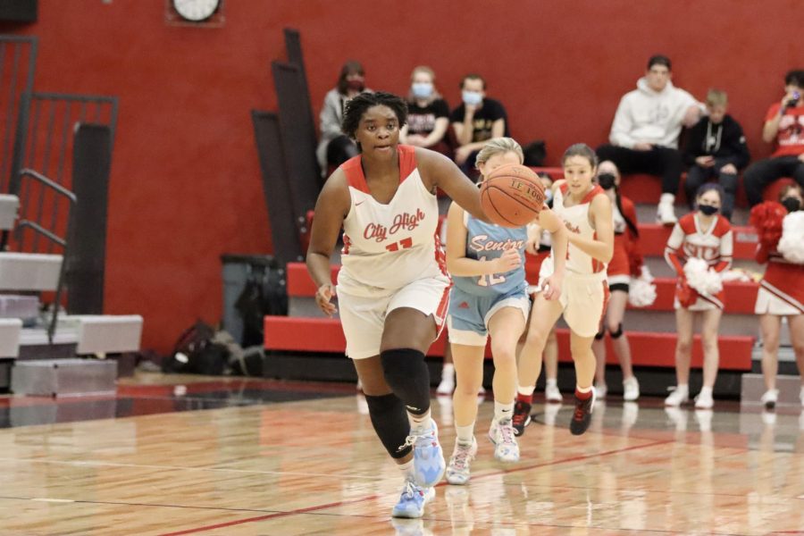 After rebounding Dubuque Senior's shot, Eviyon Richardson '22 travels down the court to make a layup.