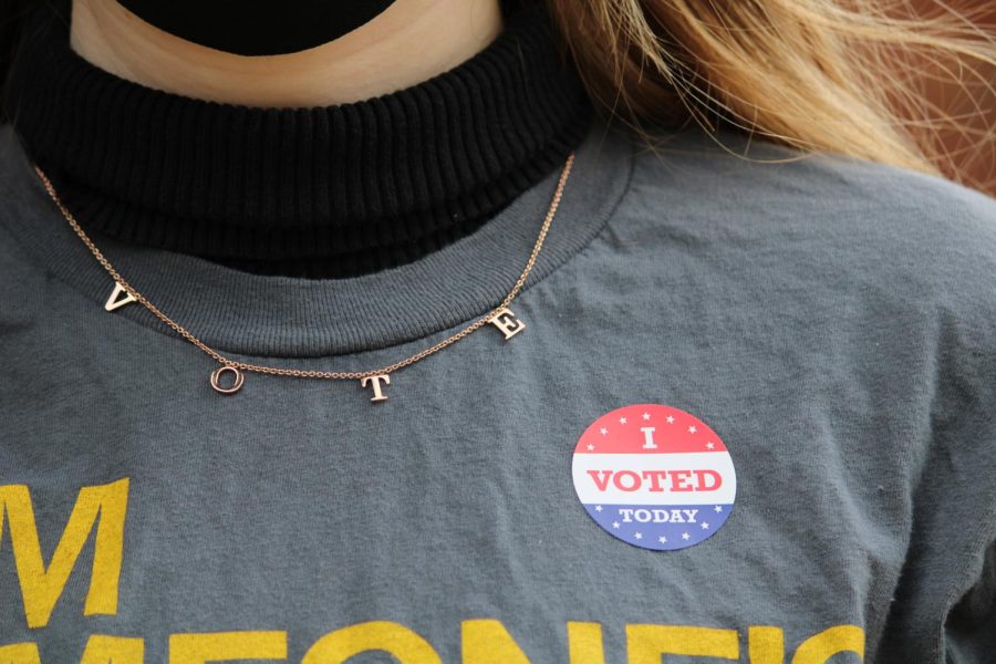 Frances Bottorff 22 poses with her I Voted sticker after voting for the first time.