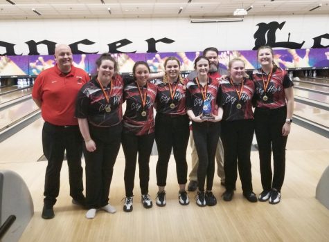 Girls Bowling team poses with their first place medals.