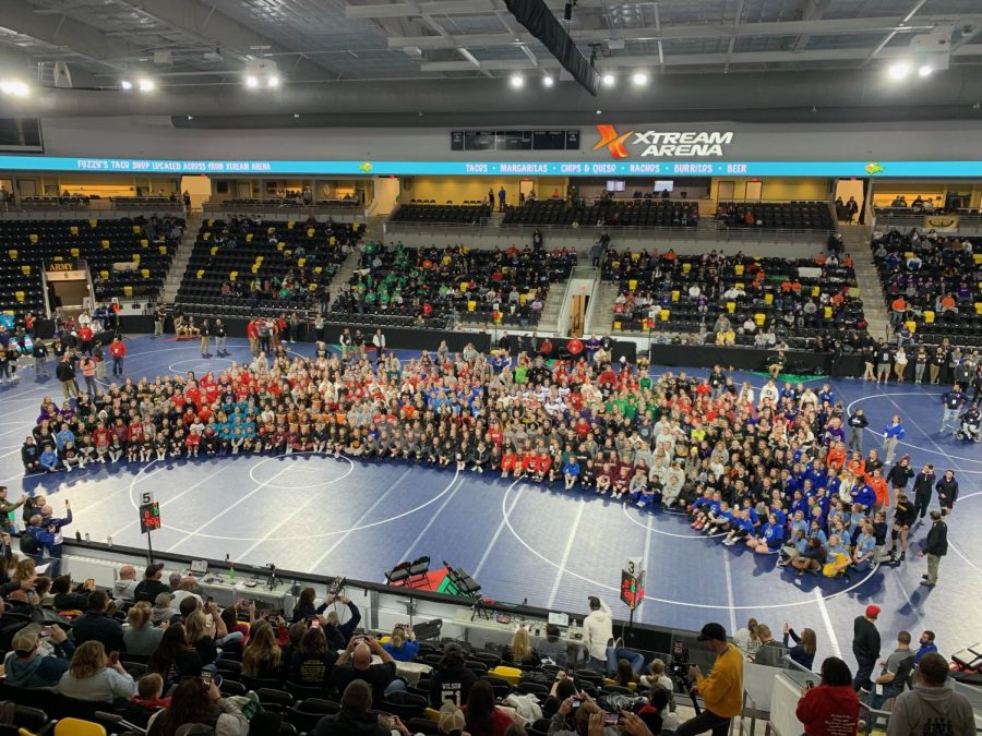 Members of the 2022 IWCOA High School Girls State Wrestling Tournament pose for a photo at the beginning of the competition.