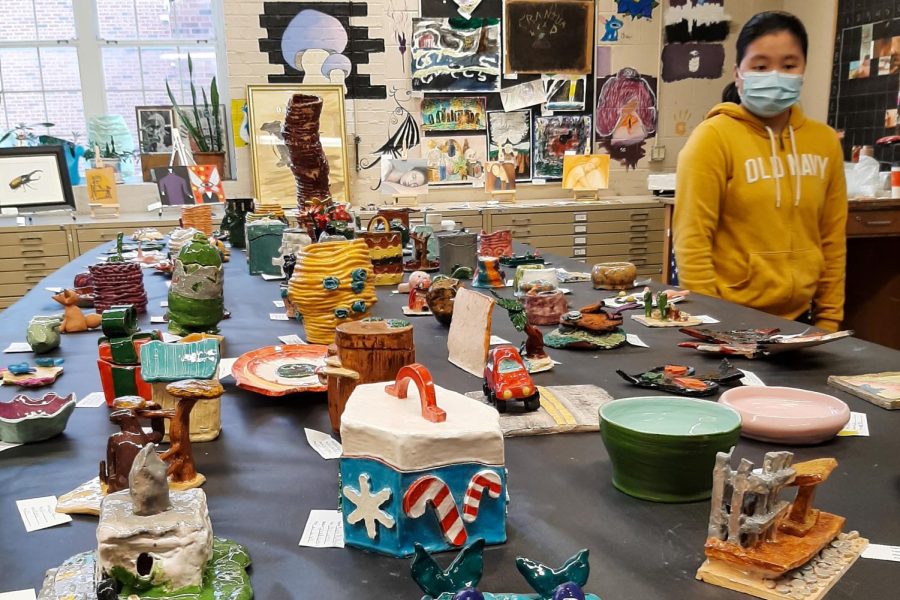 Table displaying colorful clay artwork made by ceramics classes.