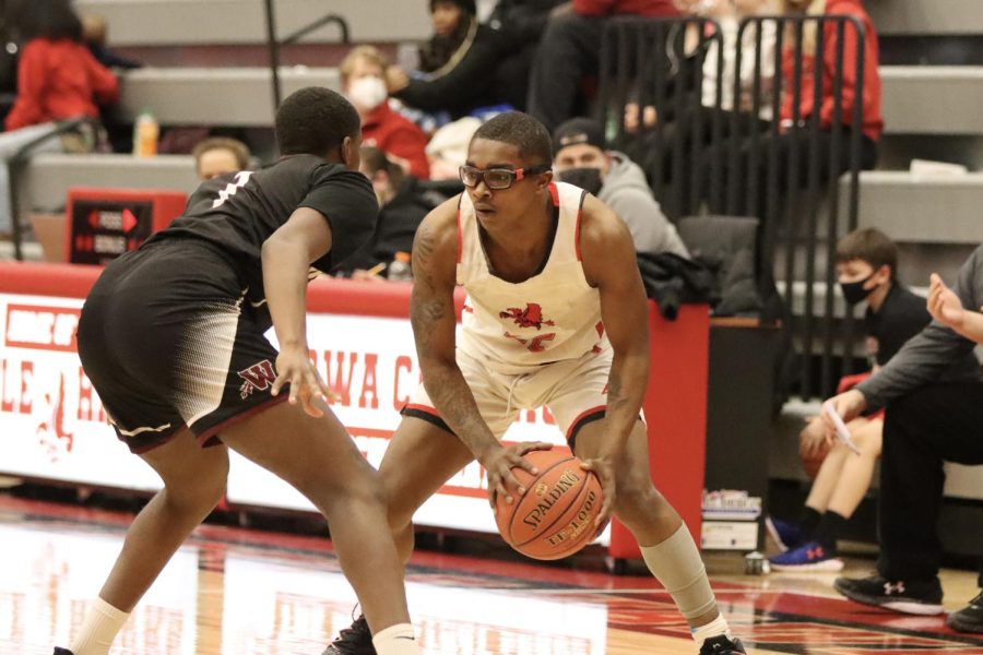 Darren Richardson 22 moves the ball around looking for an open teammate in the game against Waterloo West.