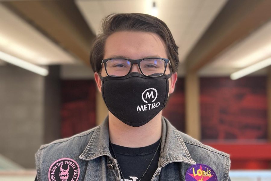 Aidan Burdinie 22 poses in City High’s Cafeteria.