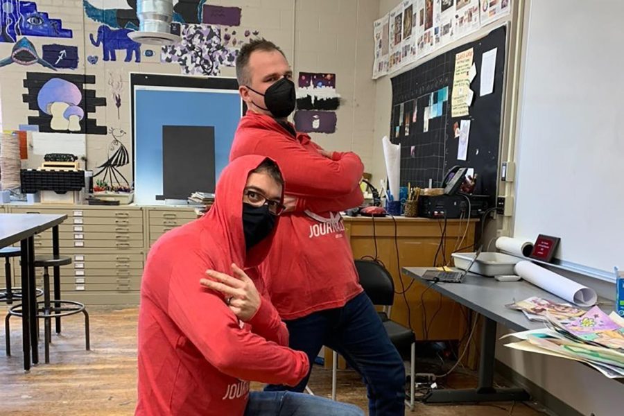 Art teachers Dan and Michael pose for a photo with their Little Hawk Journalism t-shirts they recieved for winning the Teacher award for the 2022 Cutest Couple Contest.