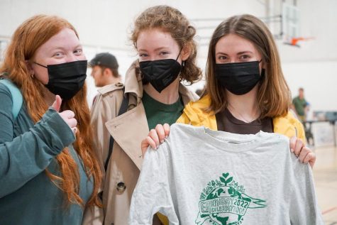 Ruth Meehan ‘22, Alice Boerner ‘22, and Callista Robertson ‘22 hold up a screen print on a used t-shirt, just one of the many activities at the Earth Day Celebration event.