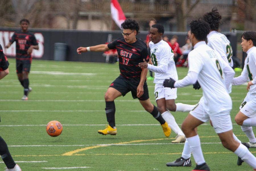 Alfredo Ortiz 22 attempts to dribble the ball around a West High defender