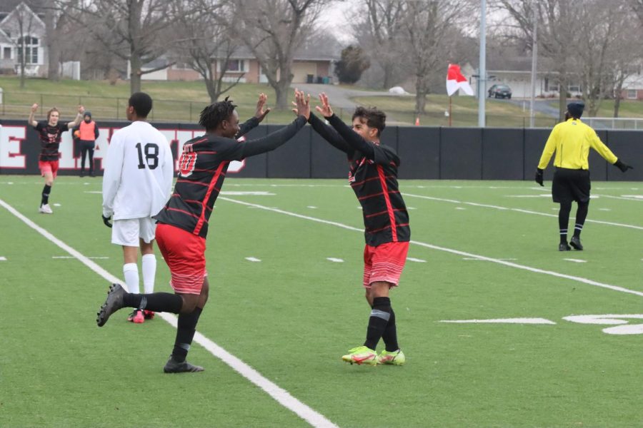 Alima Mmunga 23  and Andrew Lopez 23 high five after scoring. 