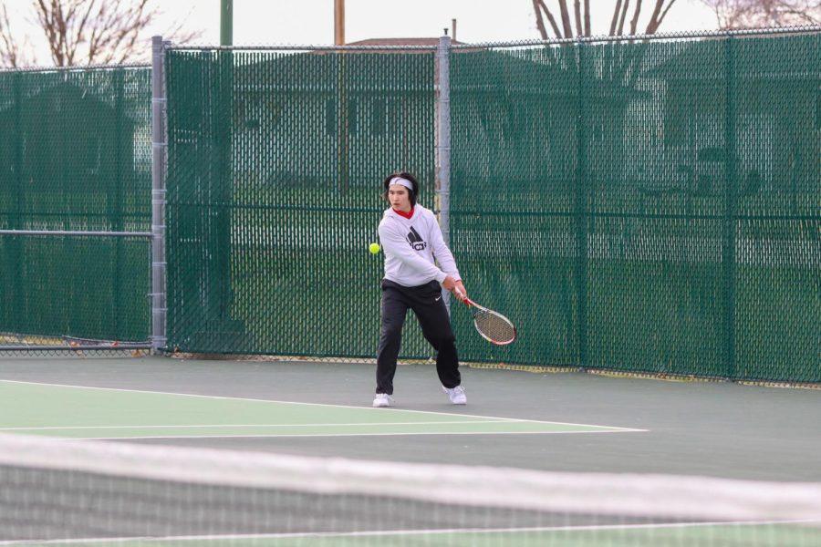 Adrian Bostain 23 prepares to hit the ball back over the net.