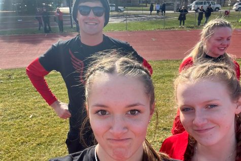 Grace Kirschling and others take a selfie with Welp at a track meet.