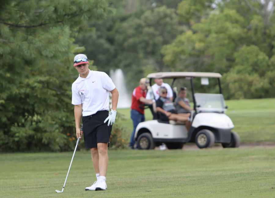 Jake Mitchell 24 lines up his shot at Pleasant Valley golf course.  Jake in his first year has helped the team with rounds in the 70s.