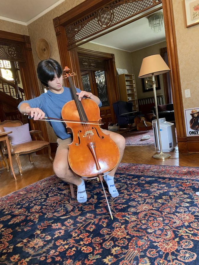 Adrian Bostian 23 plays cello in his house