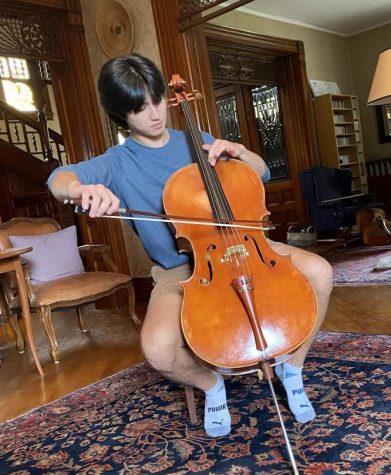 Adrian Bostian 23 plays cello in his house