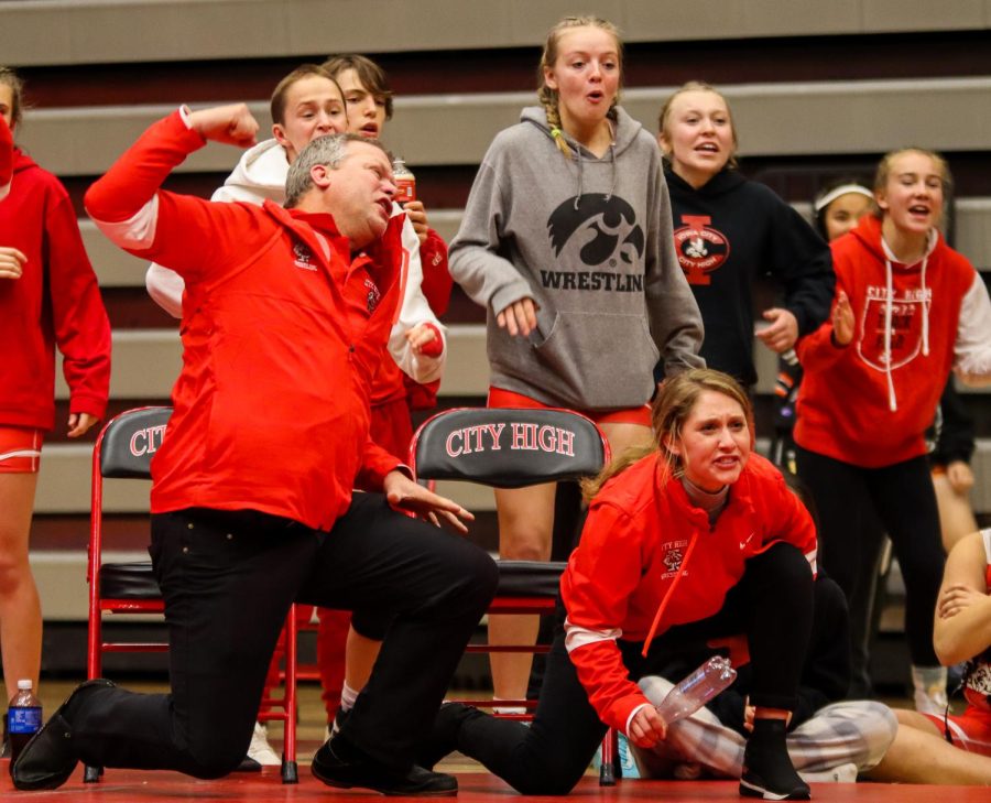 Girls wrestling coaches and players cheer on their teammate Sophie Stumbo 23 during her matchup 