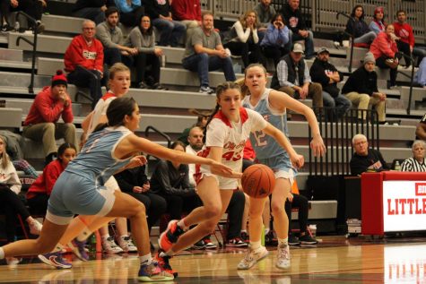 Tessa Driscoll 26 drives through two defenders in a hard fought victory against Jefferson.