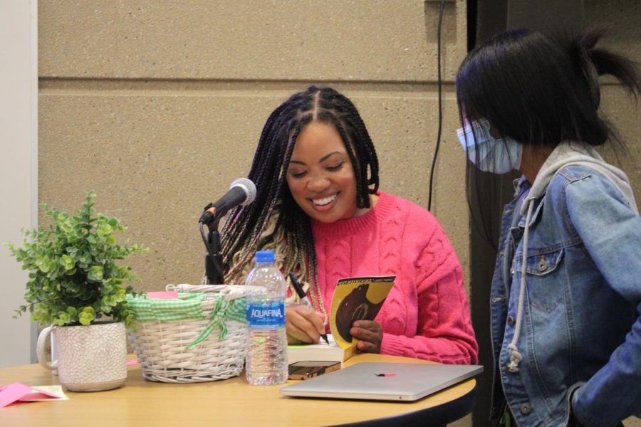 Tiffany Jackson talks with  students and signs books 