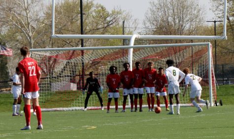 City defenders create a wall as Ben Borger-Germann 26 gets prepared for a save.  Photo by Bobby Bacon