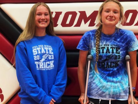 The Peterson twins pose wearing shirts from this years state track meet