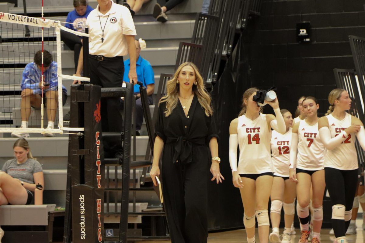 Carolyn Giese, Head Coach of the City Volleyball team, leads the team out of the locker room post-halftime