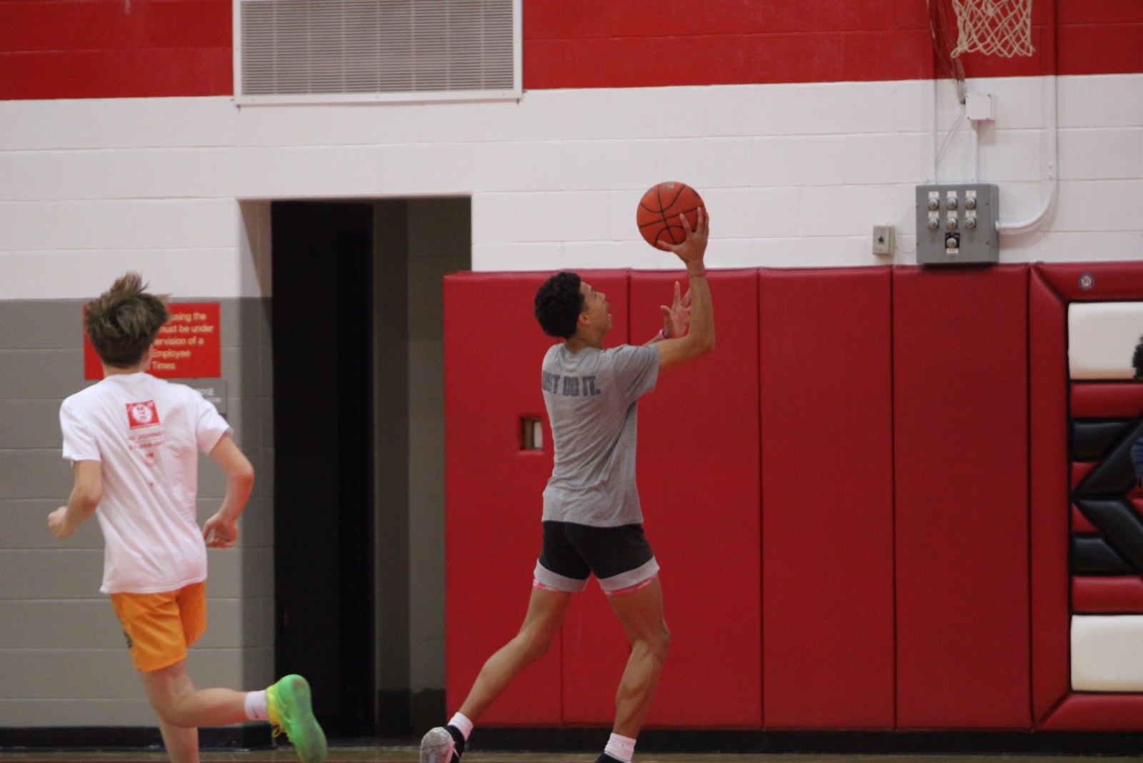 KingSton Swayzer 27 goes up for a layup in a City High Boys Basketball open gym.
