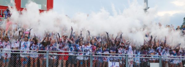 The City High student section gets hyped up during the kickoff