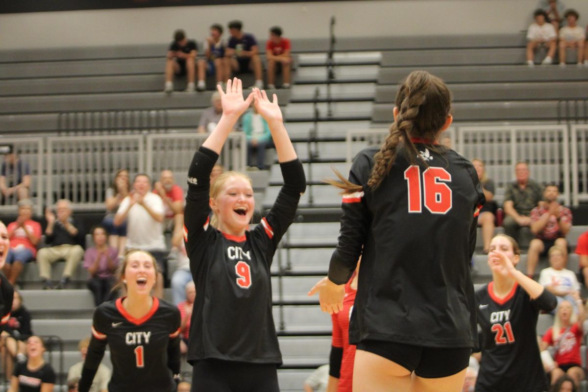 Sidney Slay 24 celebrates with Hattie Galloway 27 after scoring a point in a match against Hempstead.