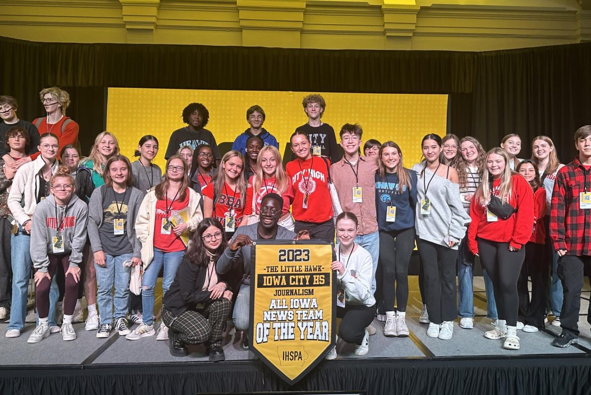 Little Hawk Journalism members pose with the All-Iowa News Team of the Year banner at the state conference