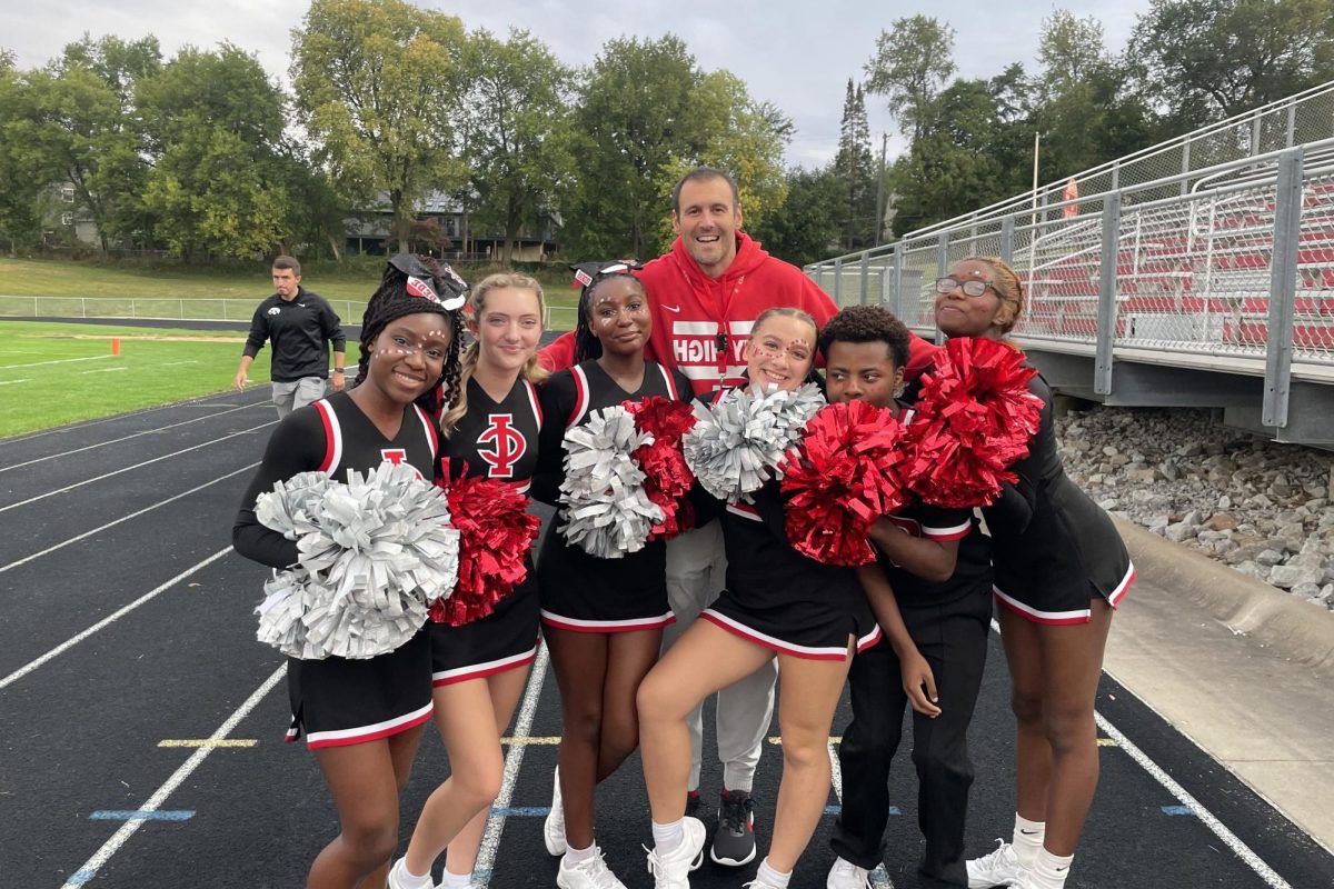 The cheer team poses with Mr. Bacon before City Highs homecoming football game