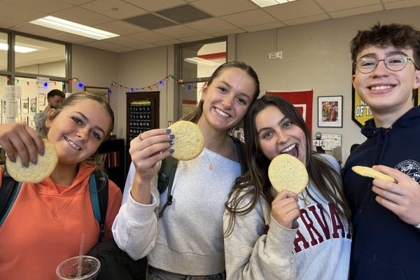 Lili Moessner, Grace Kirschling, Catalina Armstrong, and Diego Loria-Eivins ‘24 smile with chai tea sugar cookies